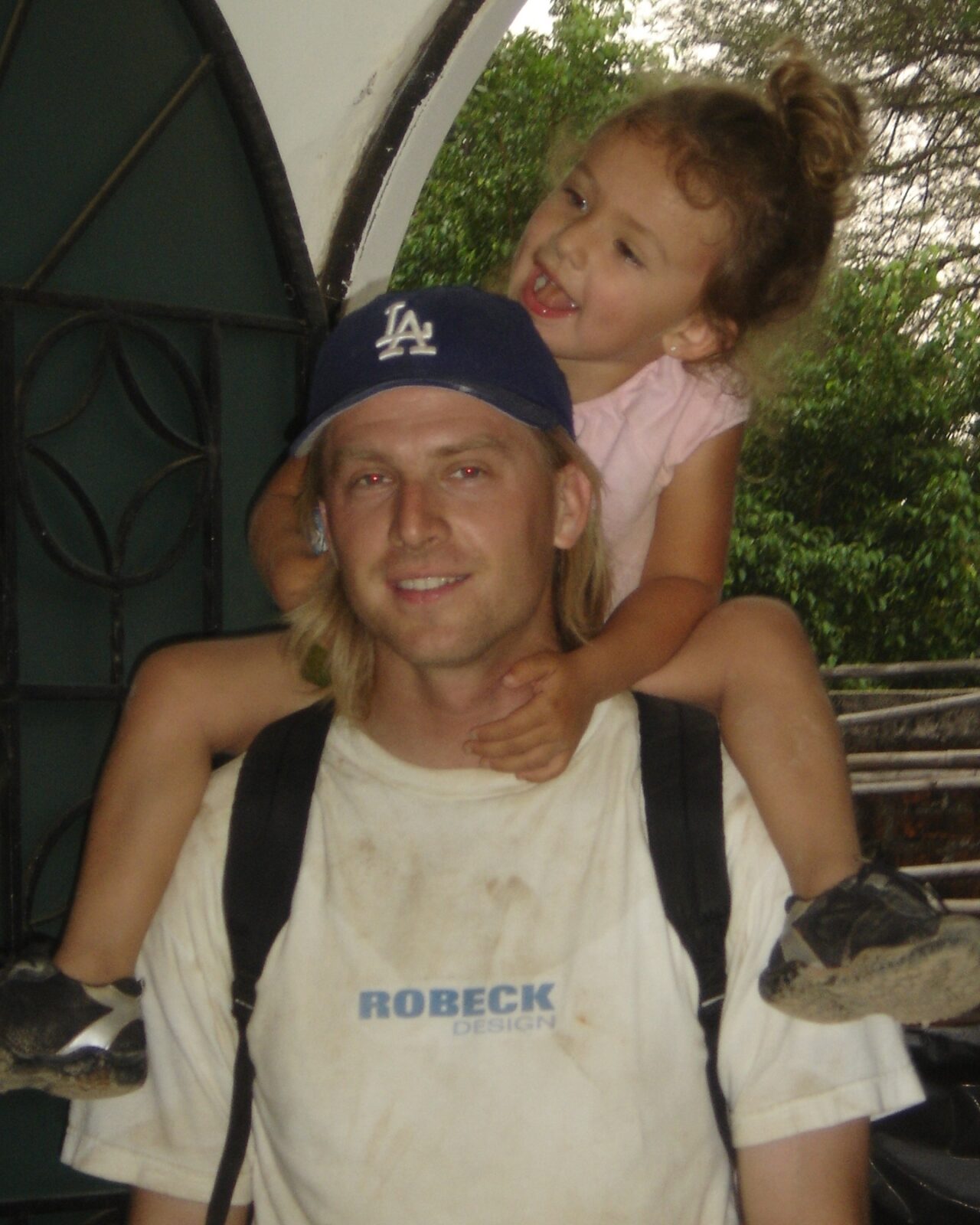 a daughter sitting on fathers shoulder